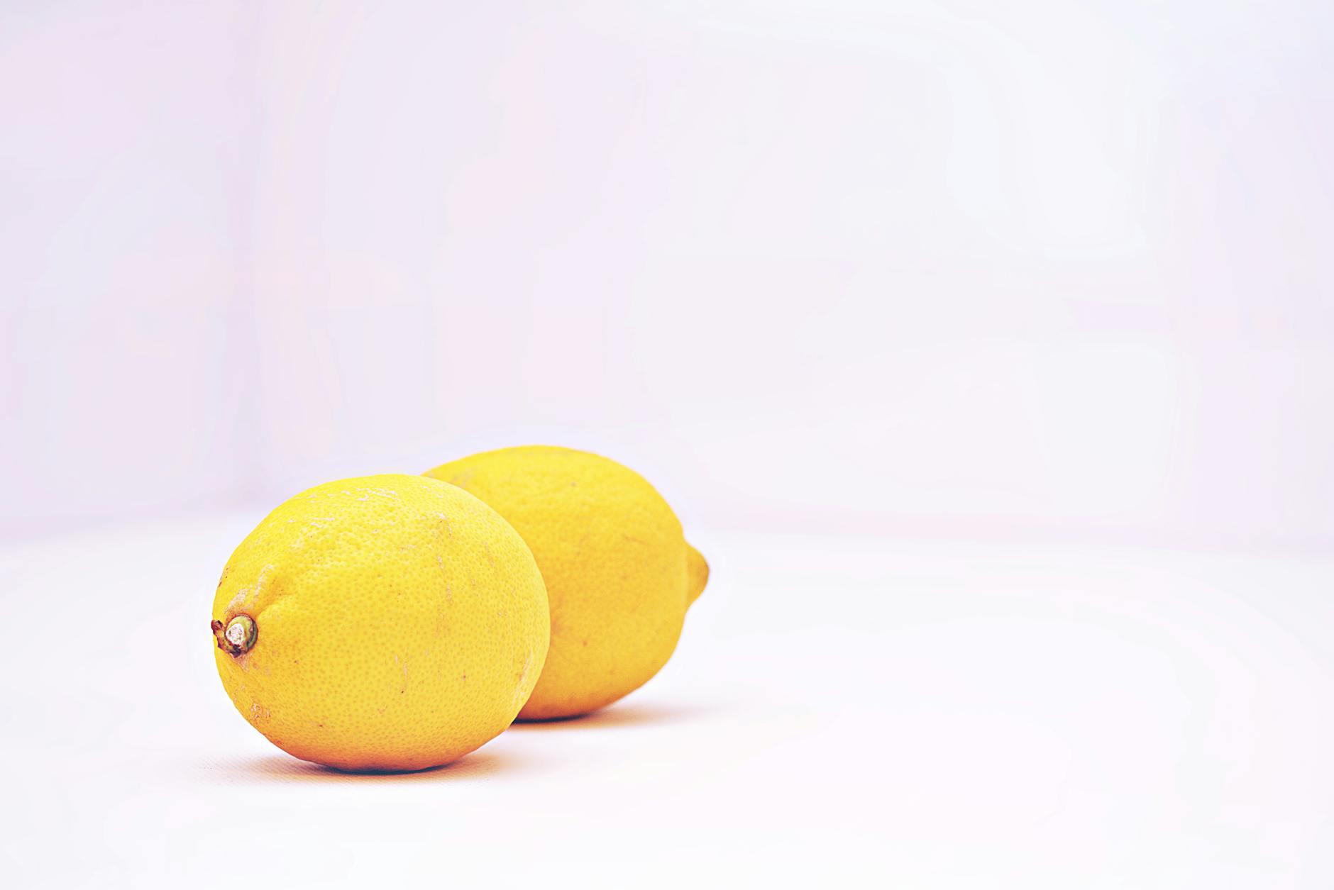 Close-up of hands holding a lemon vibrator against a knitted sweater